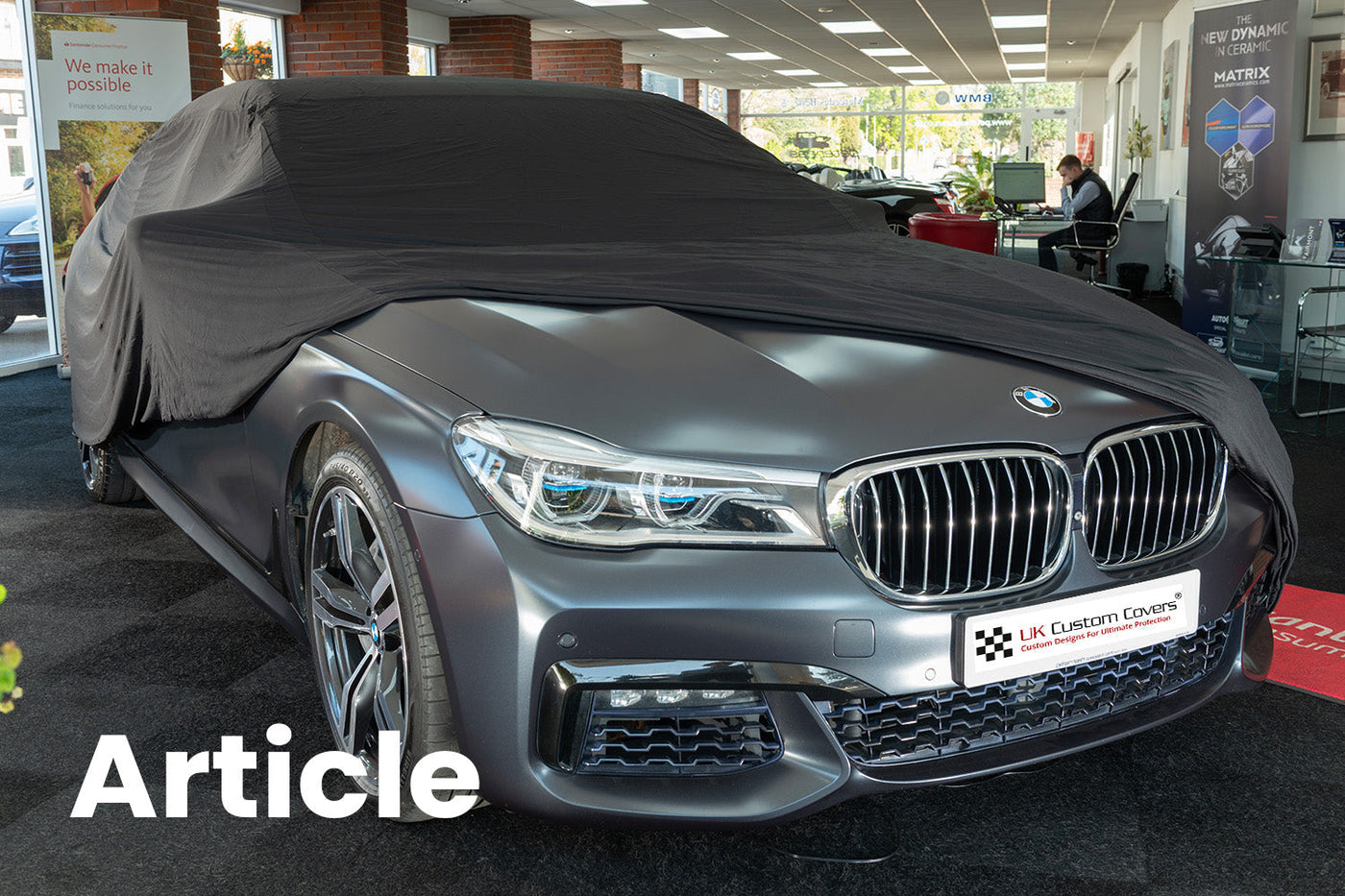 BMW with a black indoor car cover over the top showing the front of the car