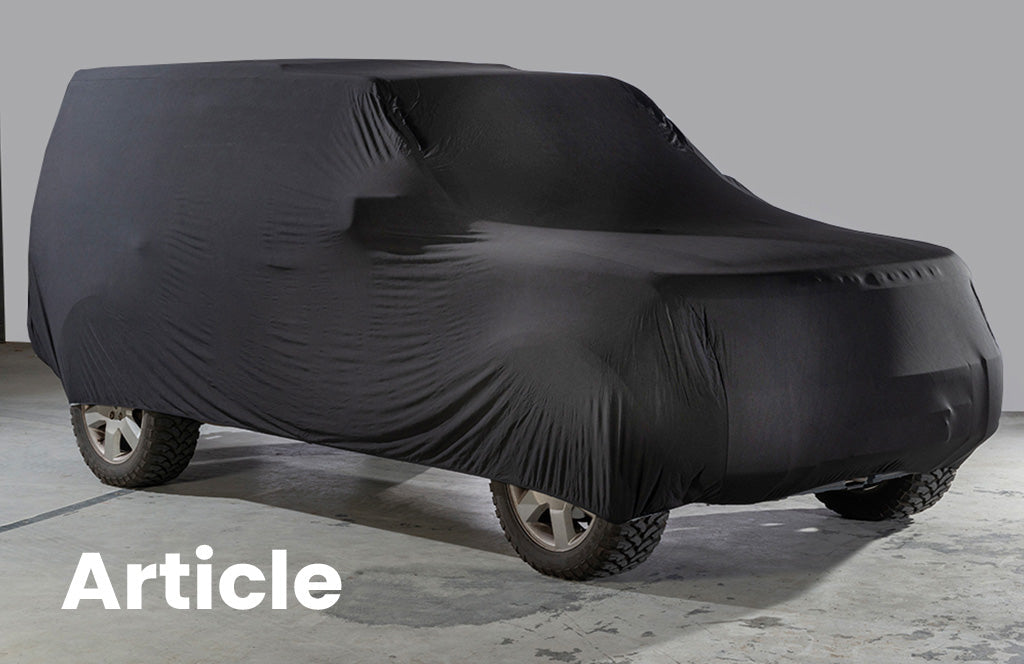 Land Rover Discovery 3 with a black indoor car cover over the top 