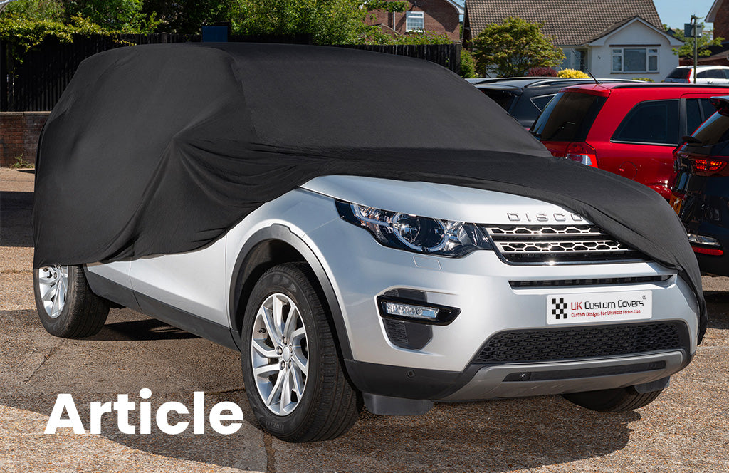 Land Rover Discovery with a black indoor car cover the top 