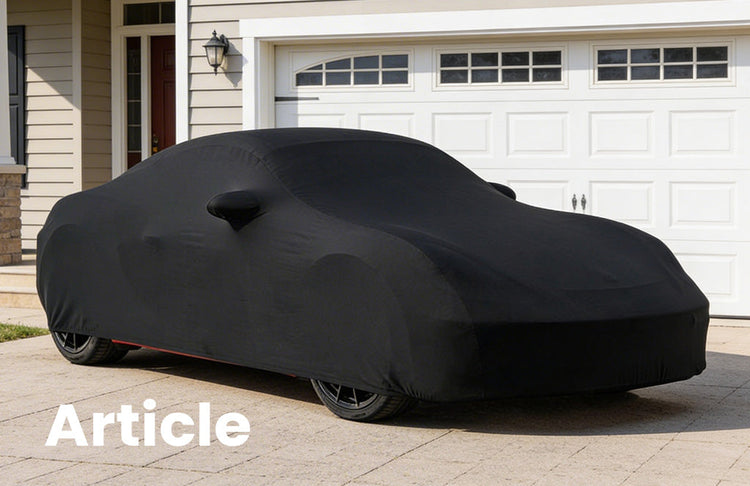 Black indoor tailored car cover over the top of a Porsche Cayman covering every curve of the vehicle