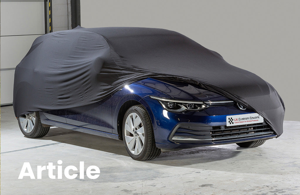 VW Golf with black indoor car cover over the top showing the front of the vehicle 